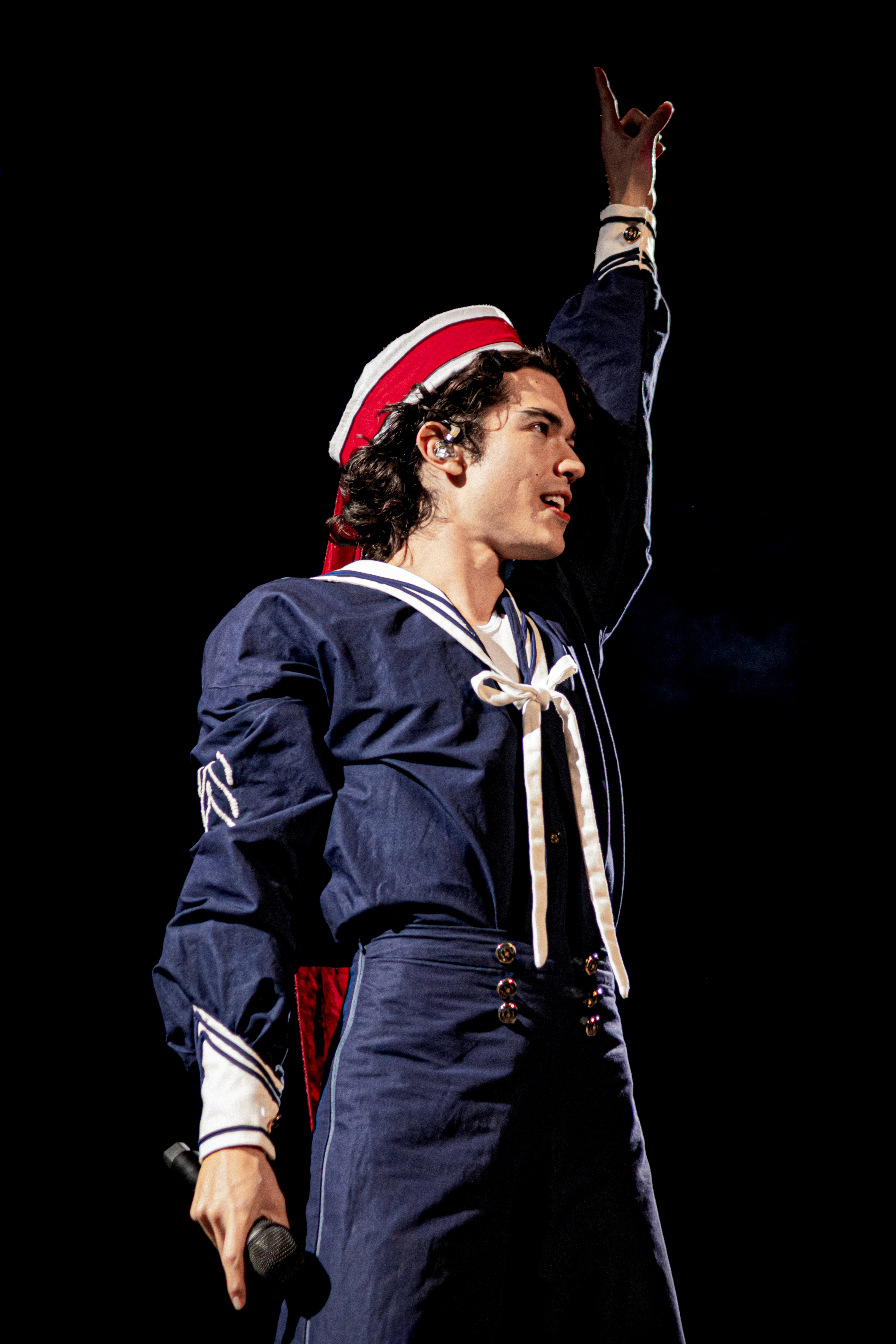 Editorial gallery of Conan Gray styled in bright winter looks with electric blues, magenta accents, and polished black, highlighting electric cobalt, icy magenta, optic white, chrome silver, and inky black.