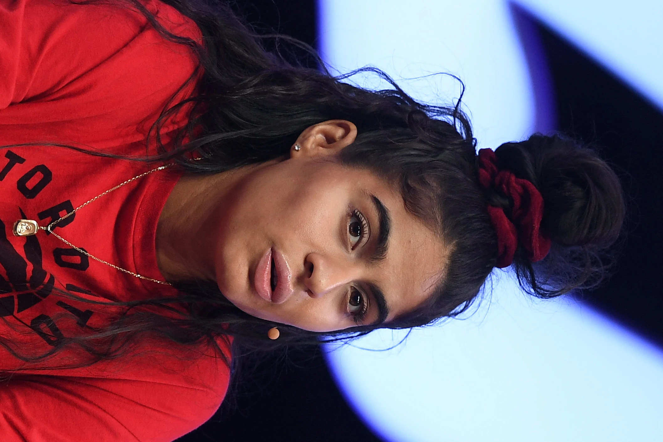 Jessie Reyez wearing luminous spring outfits with juicy warm hues, showcasing papaya orange, sunny marigold, aqua turquoise, creamy ivory, and rose gold from the Warm Spring palette.