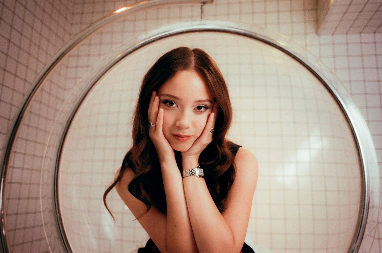 Laufey wearing deep jewel-toned ensembles with sharp contrast, showcasing midnight navy, crimson, amethyst, gunmetal, and snow white from the Deep Winter palette.