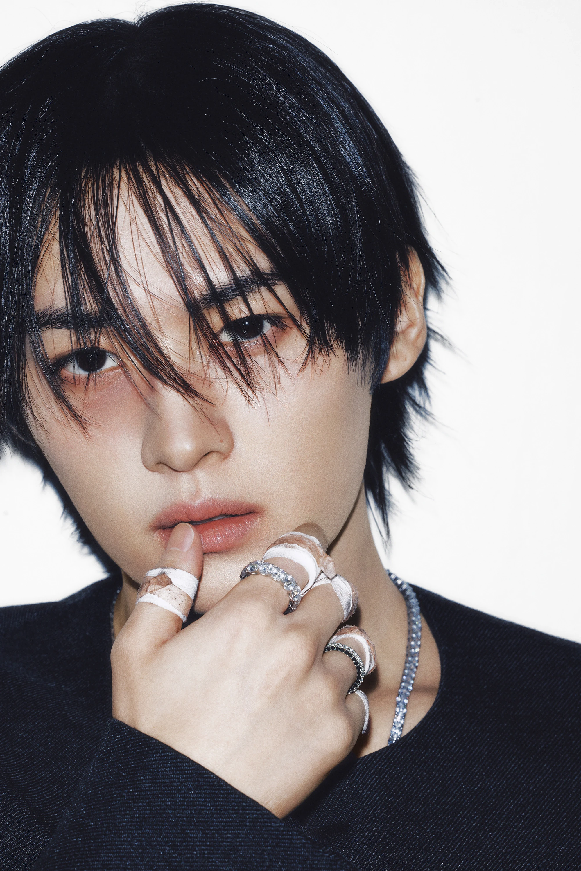 Editorial gallery of Lee Know (Stray Kids) styled in bold winter ensembles mixing neon pops, inky black, and chrome sparkle, highlighting ultra violet, neon fuchsia, electric jade, polished pewter, and onyx.