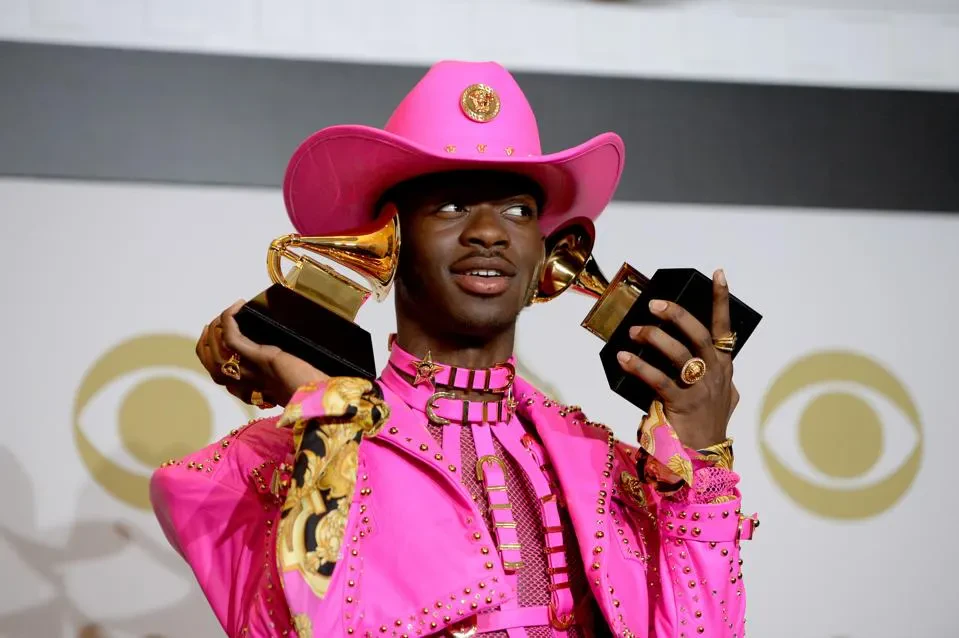 Editorial gallery of Lil Nas X styled in bright winter looks with electric blues, magenta accents, and polished black, highlighting electric cobalt, icy magenta, optic white, chrome silver, and inky black.