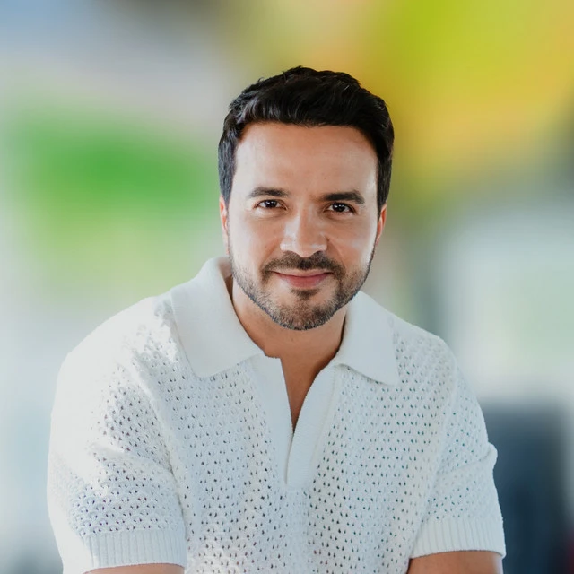 Luis Fonsi wearing high-contrast electric brights paired with sharp tailoring, showcasing ultra violet, neon fuchsia, electric jade, polished pewter, and onyx from the Bold Winter palette.