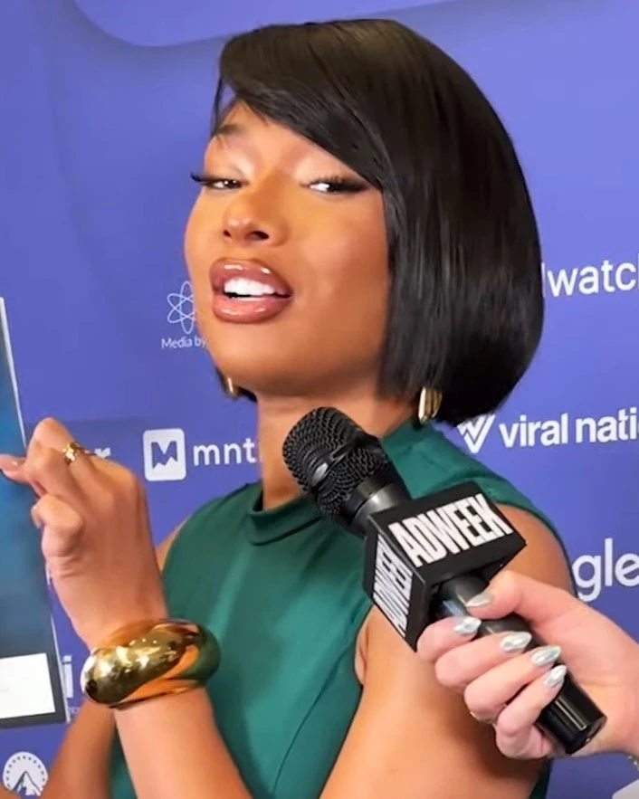 Megan Thee Stallion wearing high-contrast electric brights paired with sharp tailoring, showcasing electric teal, chrome, violet, crimson, and black from the Bold Winter palette.