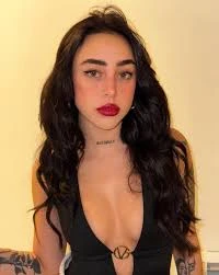 Nicki Nicole wearing jewel-toned statement dressing with crisp contrast and sparkle, showcasing electric cobalt, icy magenta, optic white, chrome silver, and inky black from the Bright Winter palette.