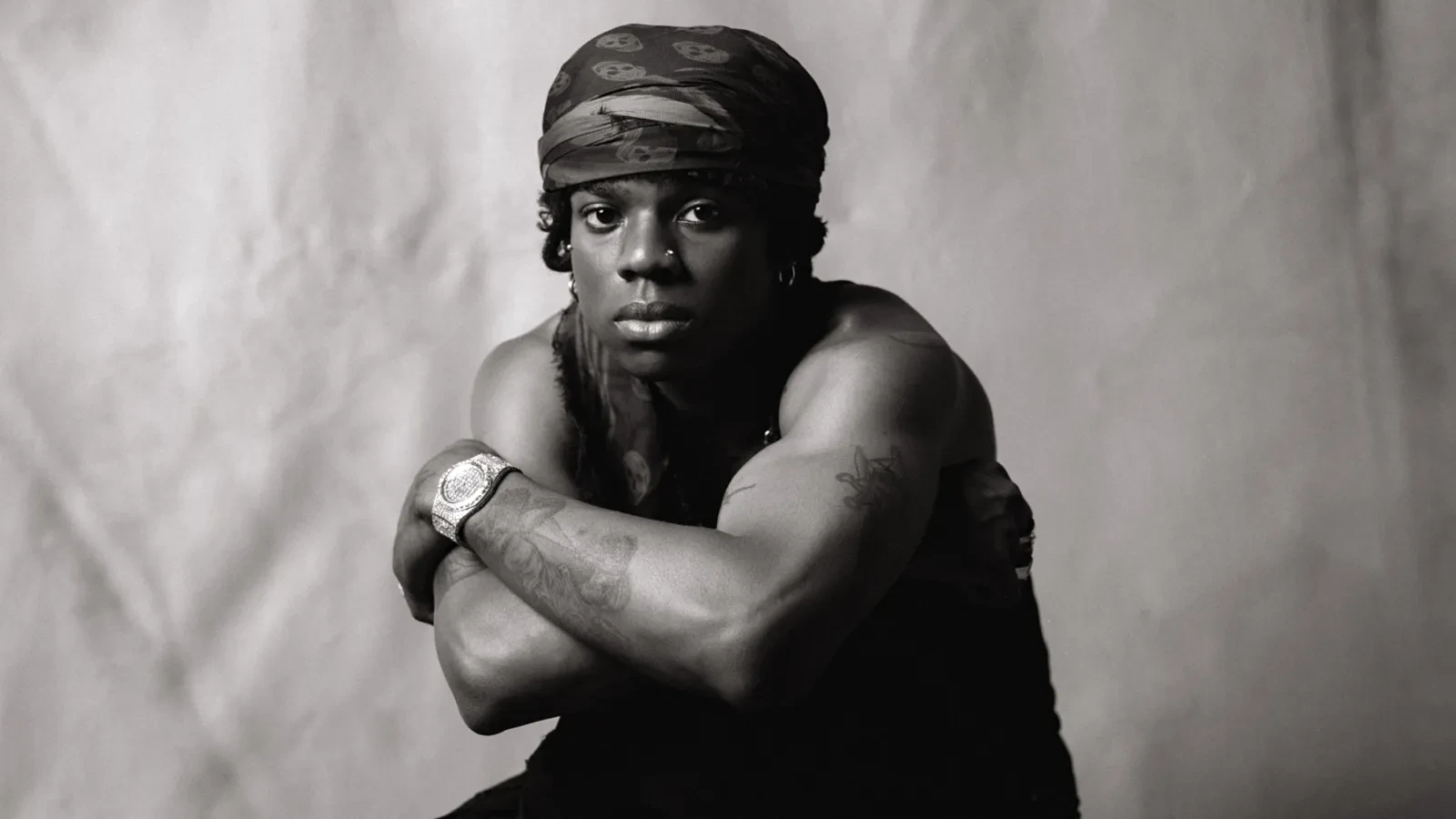 Rema wearing luminous spring outfits with juicy warm hues, showcasing papaya orange, sunny marigold, aqua turquoise, creamy ivory, and rose gold from the Warm Spring palette.