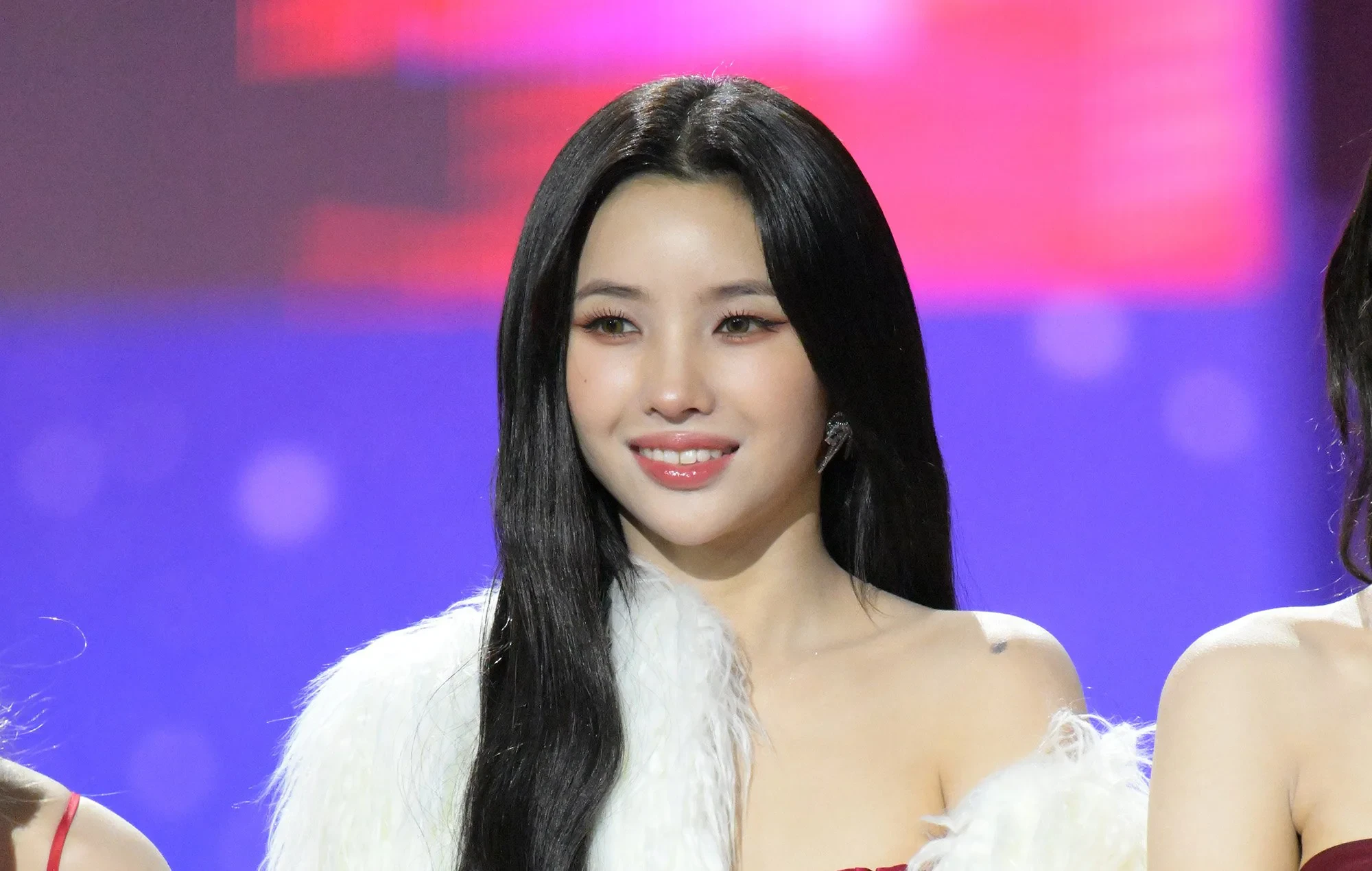 Editorial gallery of Soyeon ((G)I-DLE) styled in vibrant winter looks mixing neon brights, sharp blacks, and metallic shine, highlighting fuchsia, royal blue, silver chrome, acid lime, and deep plum.