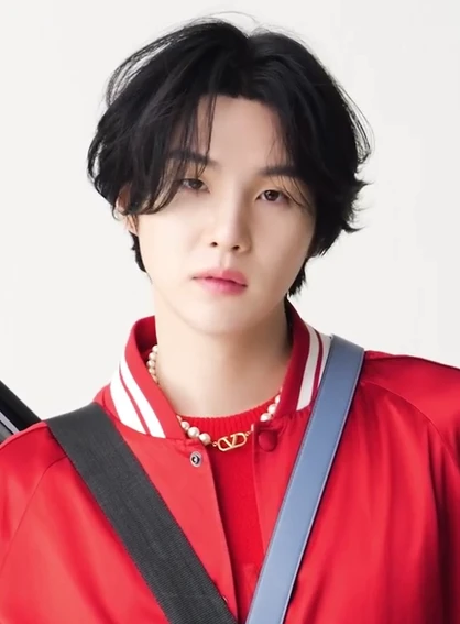 Suga (BTS) wearing high-contrast electric brights paired with sharp tailoring, showcasing ultra violet, neon fuchsia, electric jade, polished pewter, and onyx from the Bold Winter palette.